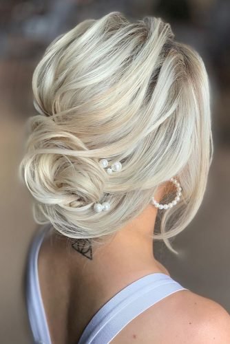 wedding bun hairstyles low updo with pearly pin and soft waves kristinagasperasacademy
